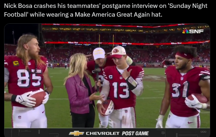 Football players on the field during a postgame interview; one wears a red cap while others, including an NFL reporter, stand nearby. Amidst them is Nick Bosa of the San Francisco 49ers, sharing insights on the game.